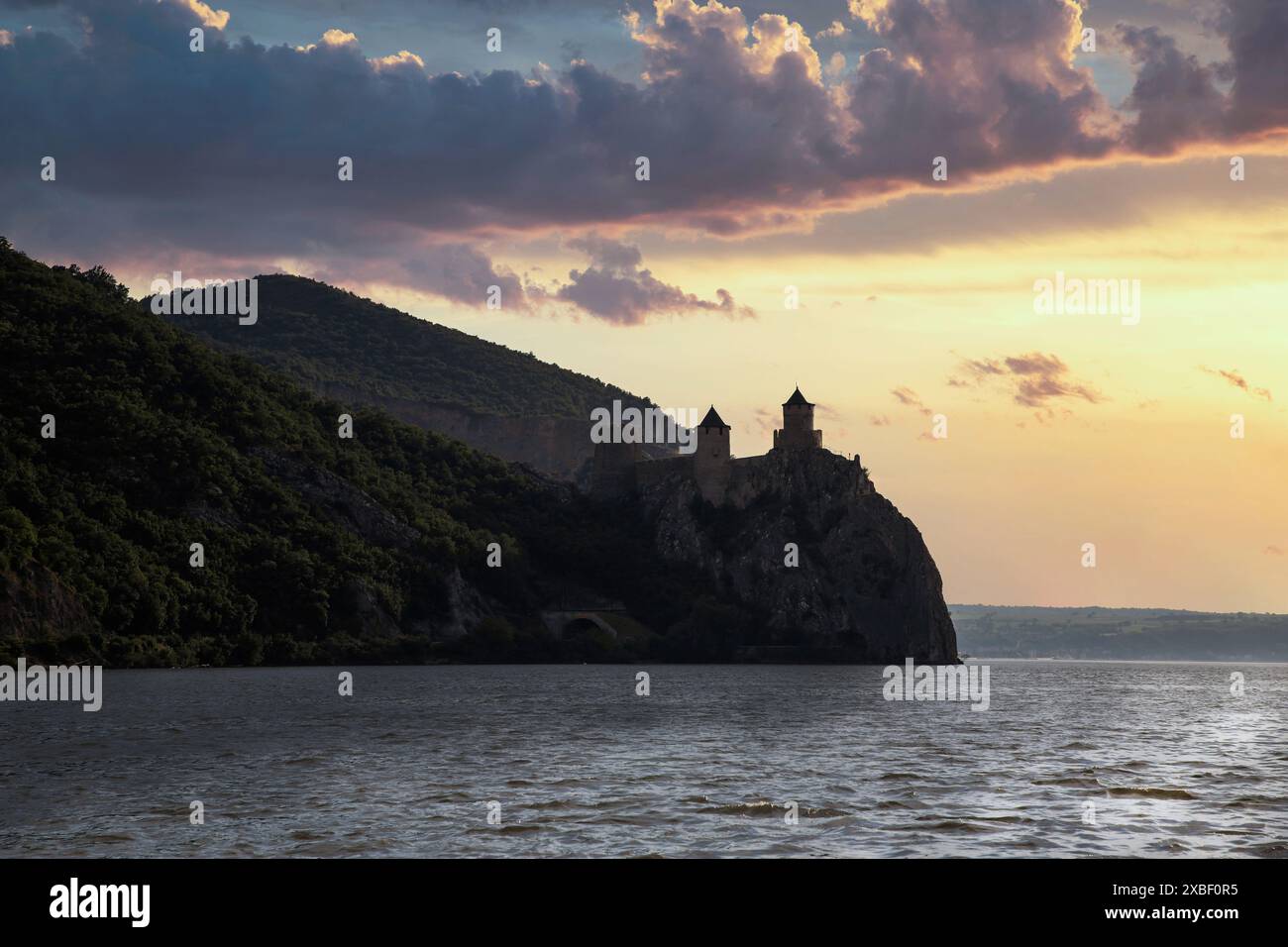 Serbia, May 2024: The breathtaking view from the Danube River of Golubac Fortress during sunset. Stock Photo