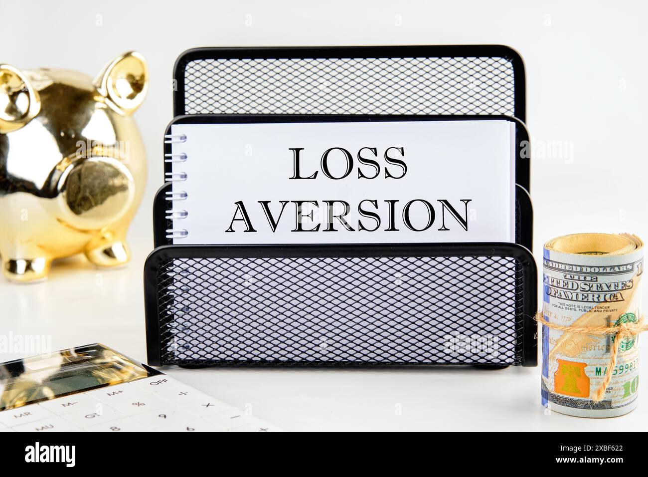 Business concept. The inscription Loss Aversion on a blank sheet in a ...