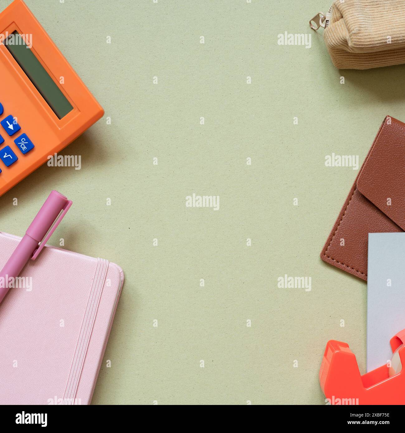 Various office and school supply. calculator, pen, notebook, pencil case, card wallet, memo pad, tape dispenser on khaki desk background. top view Stock Photo