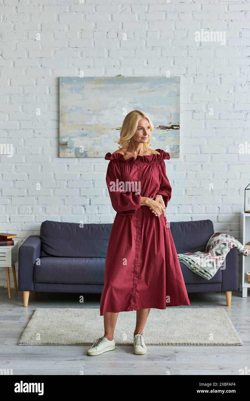 Woman in red dress stands hi-res stock photography and images - Alamy