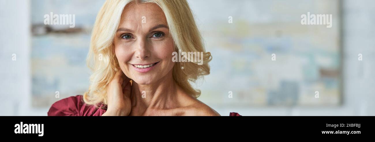 Elegant woman in a red dress smiling warmly Stock Photo - Alamy