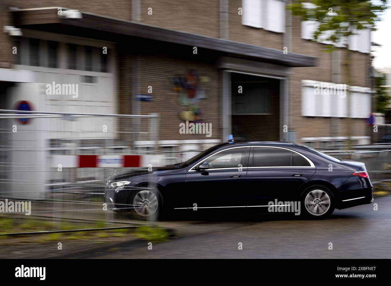 AMSTERDAM - A secured car arrives prior to the verdict in the case regarding the murder of crime reporter Peter R. de Vries. He was shot in the middle of the street in Amsterdam almost three years ago and died from his injuries nine days later. ANP SEM VAN DER WAL netherlands out - belgium out Stock Photo