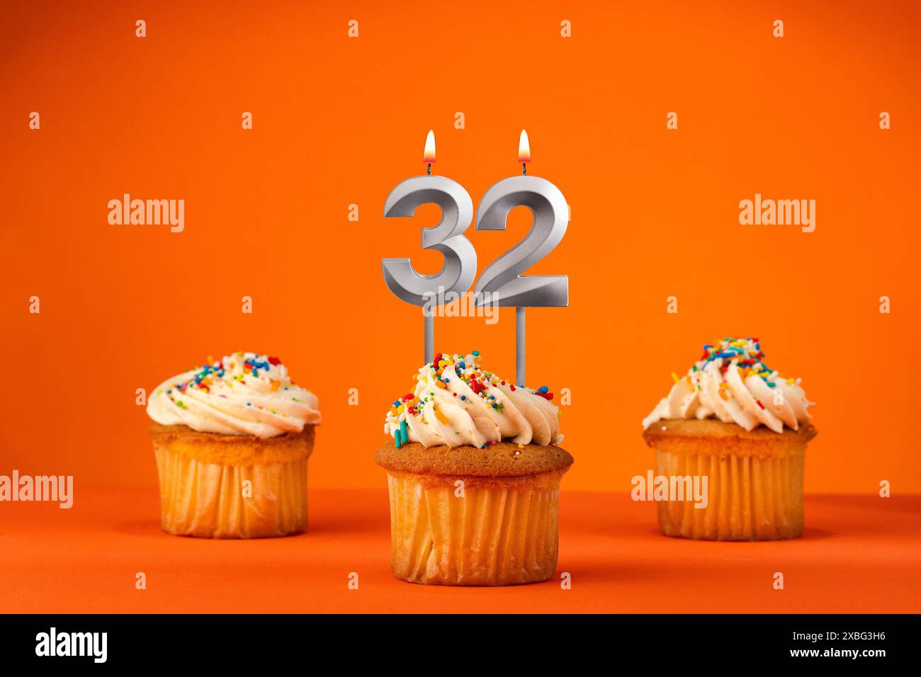 Birthday celebration in orange color - Candle number 32 Stock Photo - Alamy