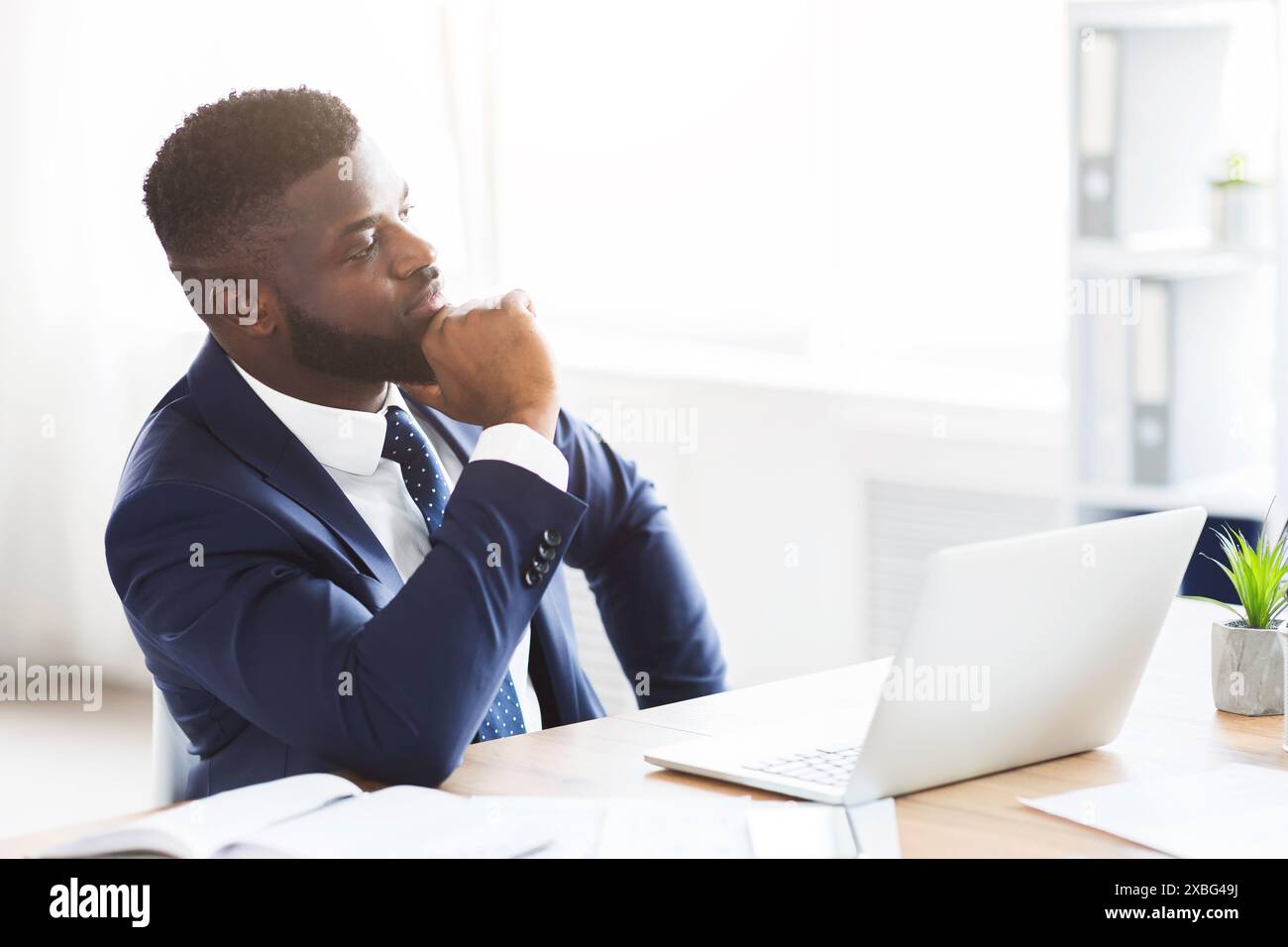 Thoughtful businessman making business solution at workplace Stock Photo