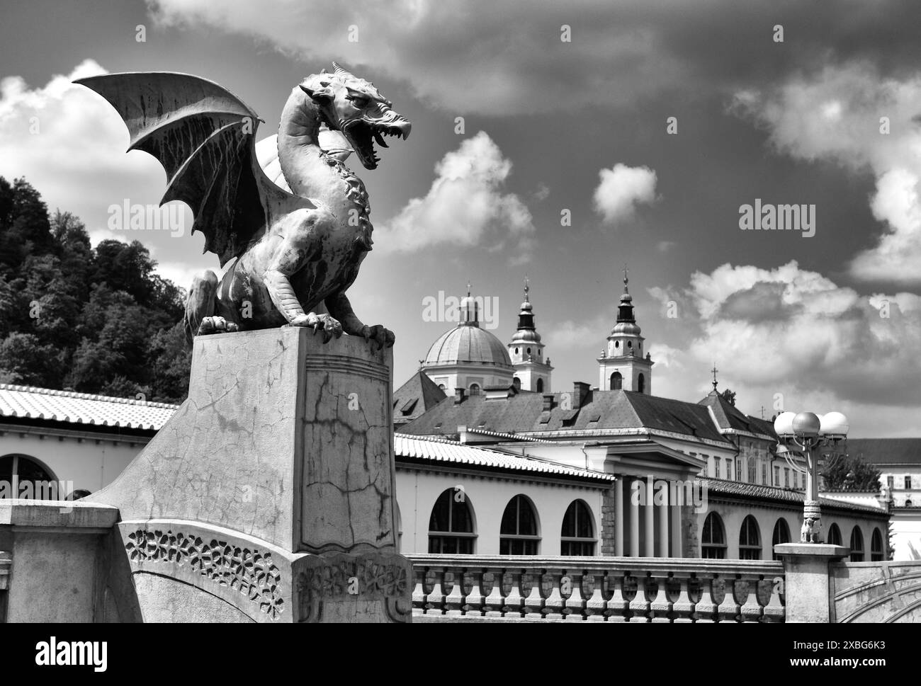 The Dragon Bridge, adorned with famous dragon statues and Cathedral of St. Nicholas at the background in Ljubljana, Slovenia Stock Photo