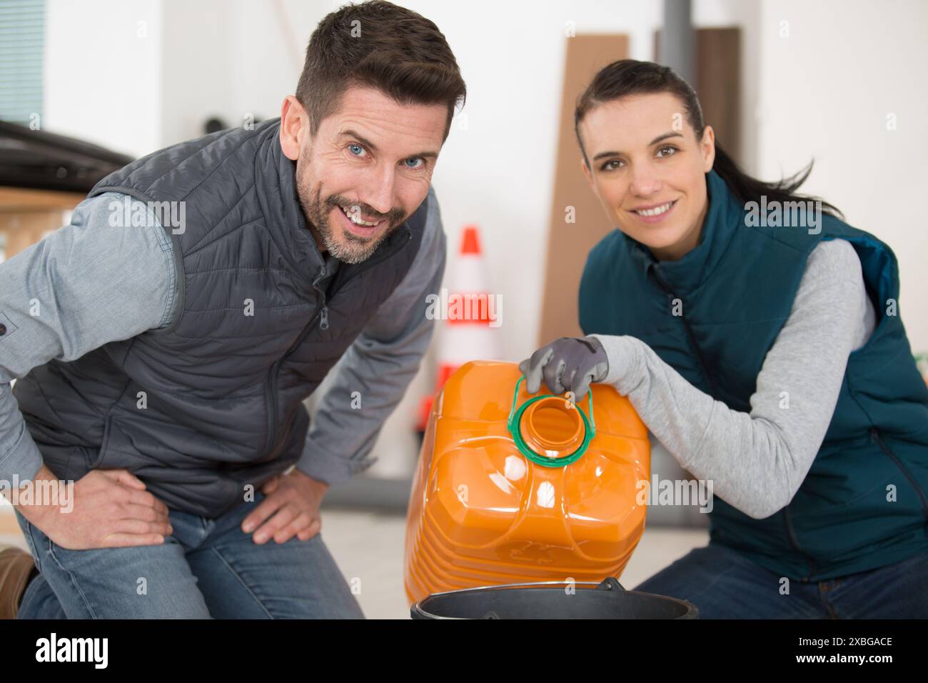 Factory worker holding oil bottles hi-res stock photography and images ...