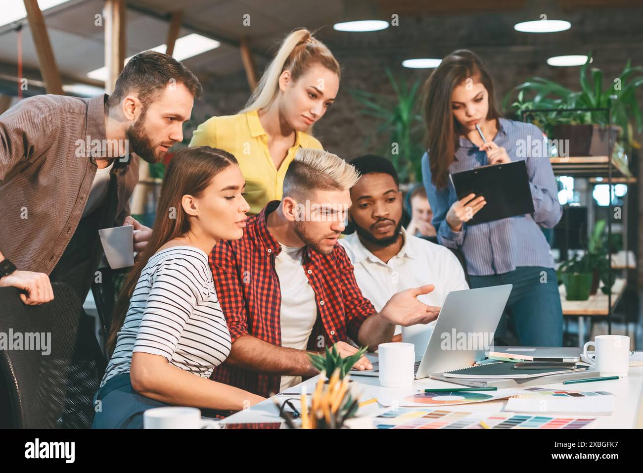 Startup concept. Young colleagues working on new project Stock Photo