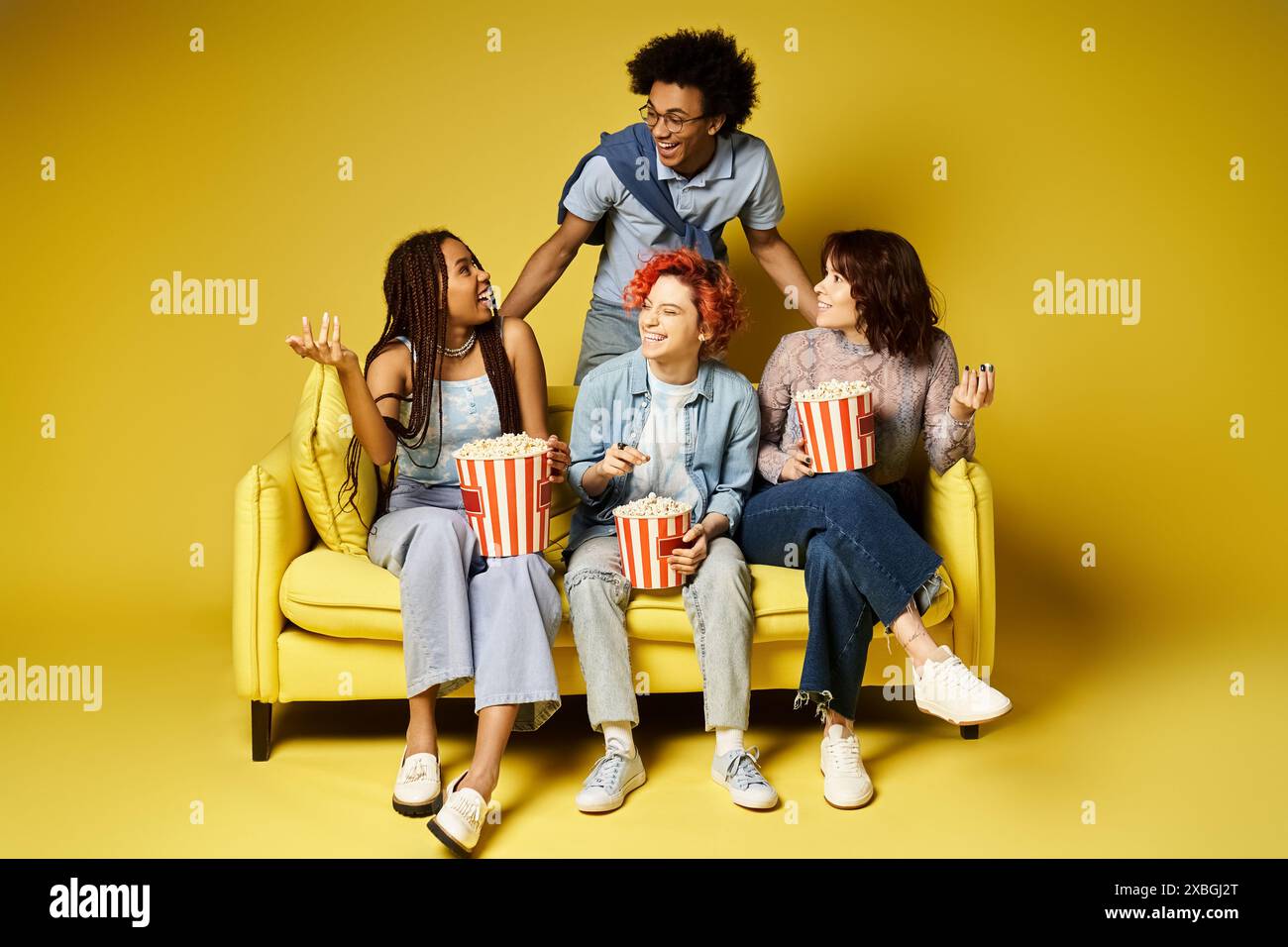 A diverse group of friends in stylish attire casually sitting on a ...