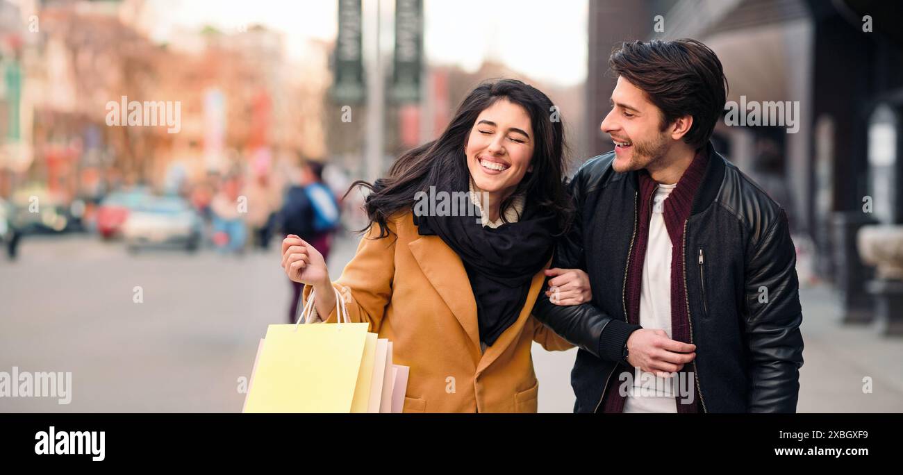 Excited couple doing shopping on weekend together Stock Photo