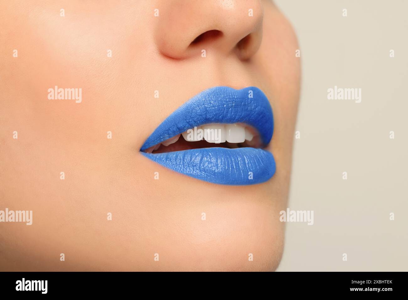 Woman wearing blue lipstick on light background, closeup. Space for text Stock Photo