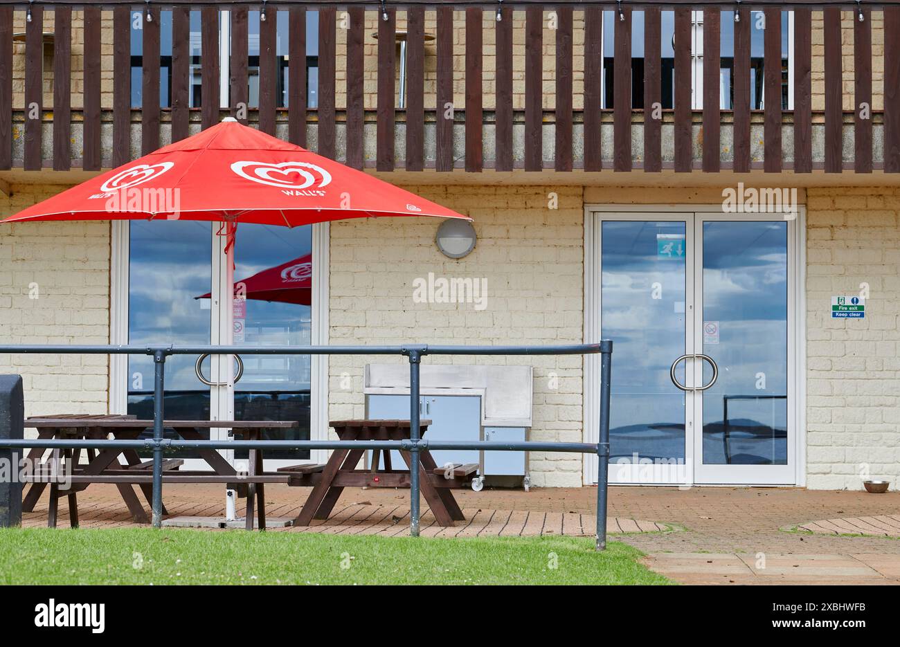 Red umbrella at The Harbour Café, Rutland Water lake, England. Stock Photo