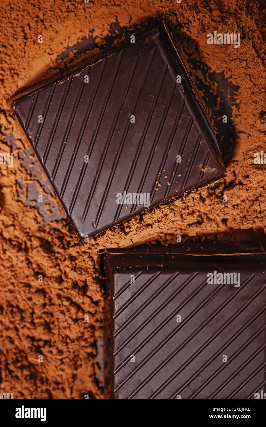 Close-up view of chocolate bar pieces on cocoa powder Stock Photo - Alamy