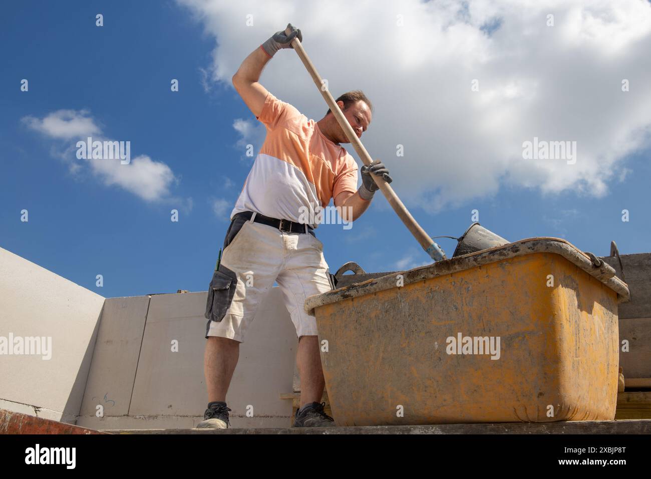 Bricklayer working on the construction site for a new detached house Stock Photo