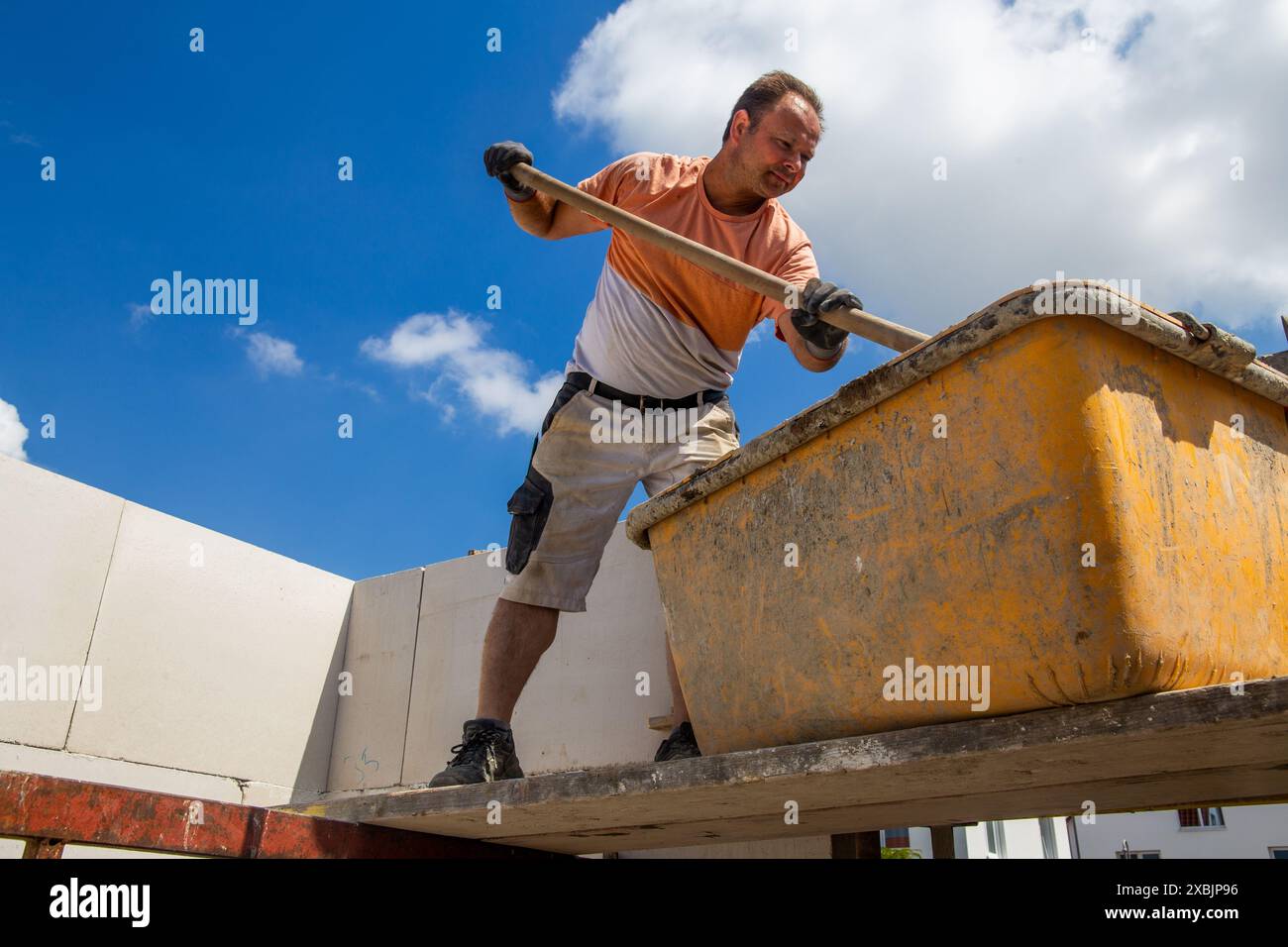 Bricklayer working on the construction site for a new detached house Stock Photo