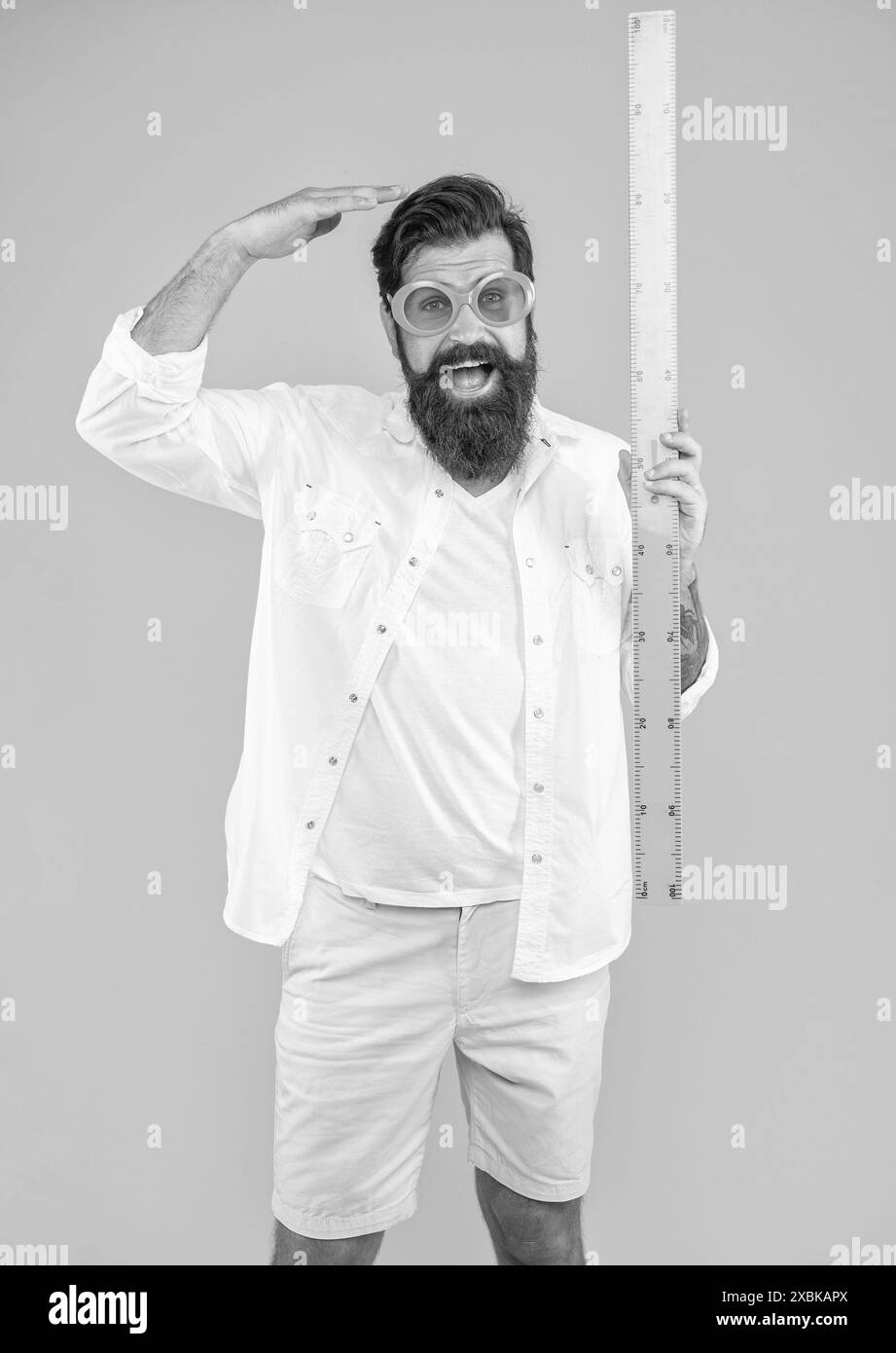 man hold measuring ruler shocked with height on background Stock Photo ...