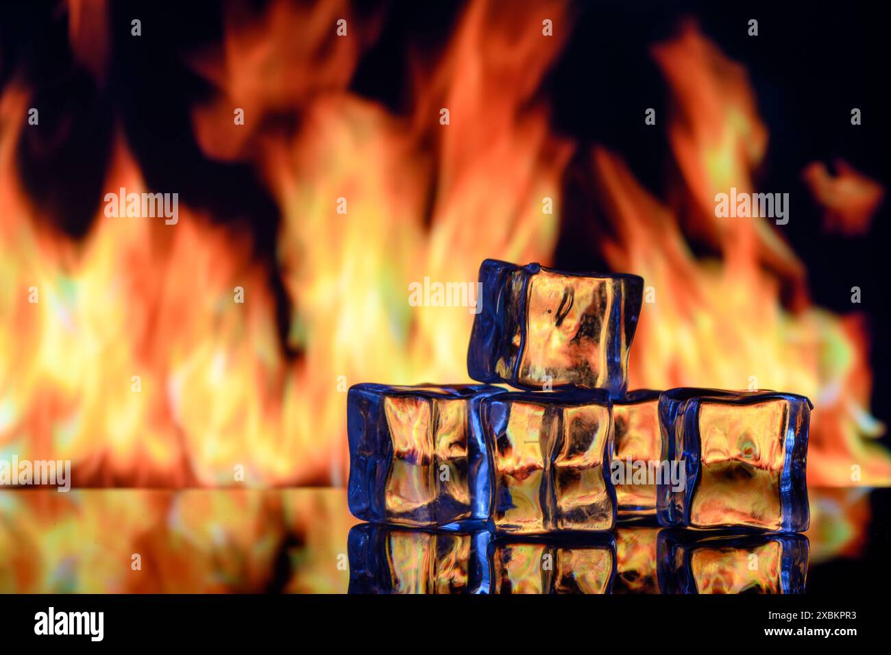 ice cubes on a black background in flames 7 Stock Photo - Alamy