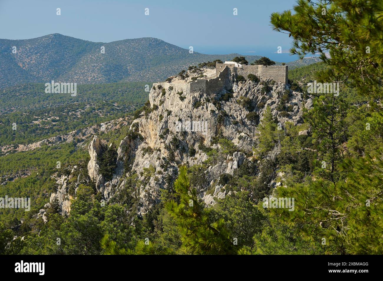 A medieval castle on a rocky hill in the middle of a forest, Kastro ...