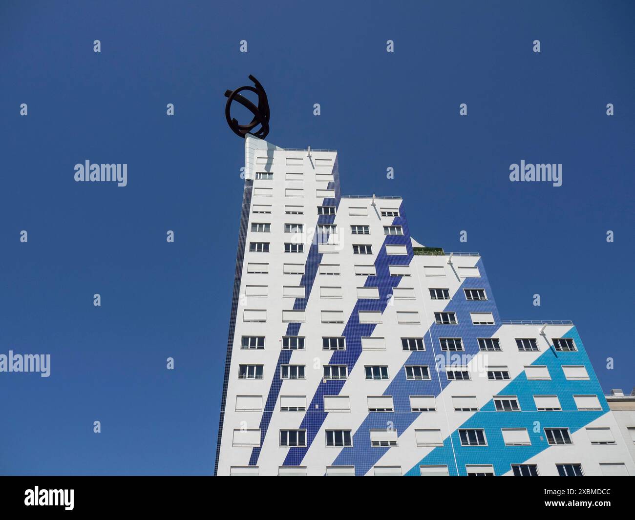 Modern building with blue and white facade and ornate structure under a ...