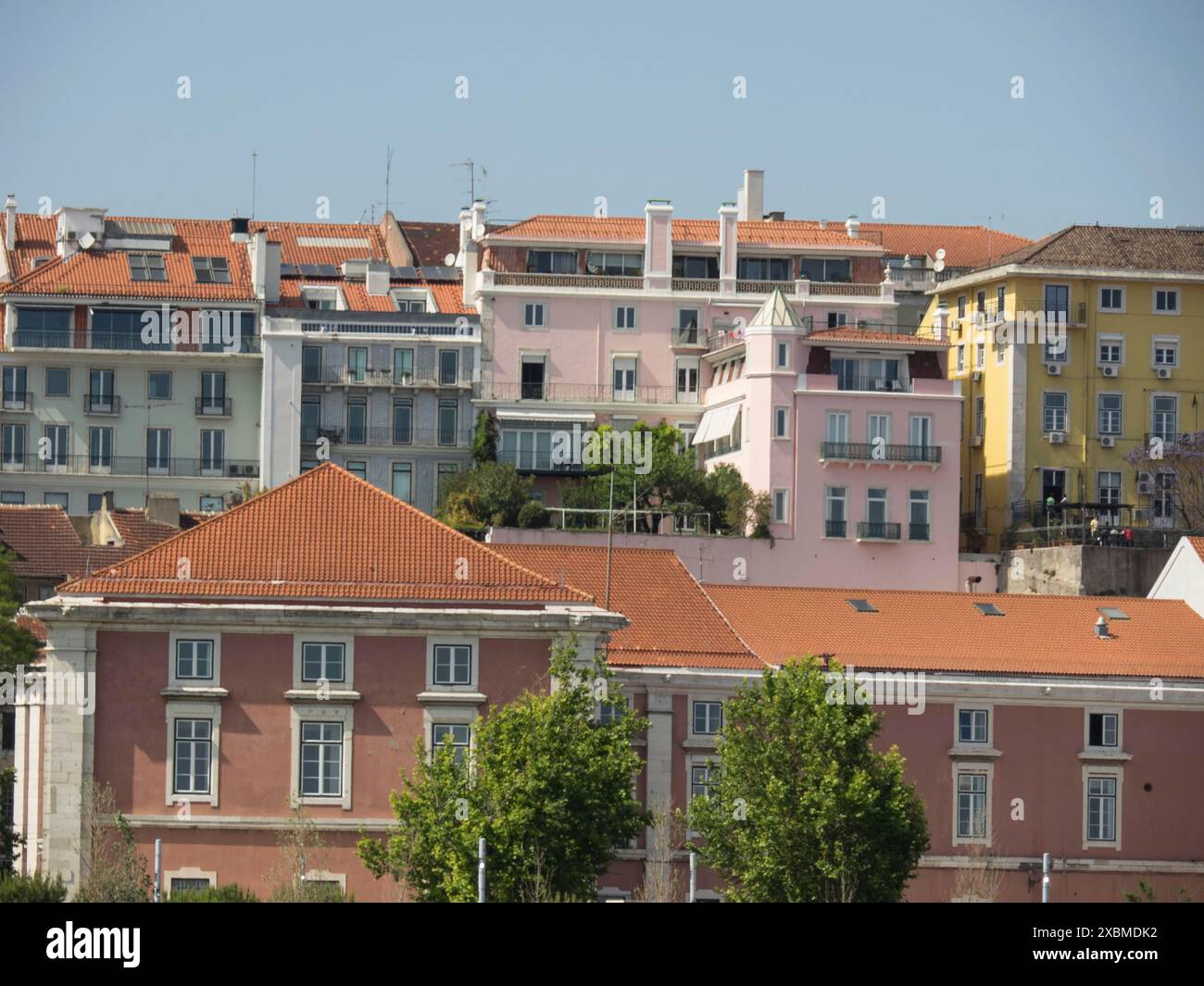 Historic buildings with pastelcoloured facades and red roofs on a