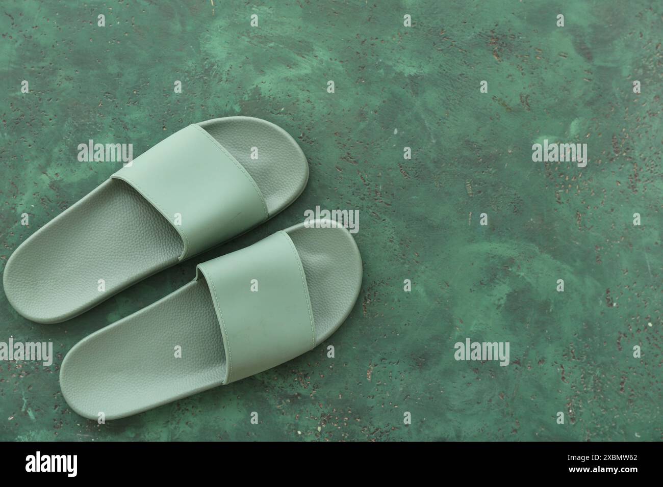 Pair of flip flops on grunge green background Stock Photo - Alamy