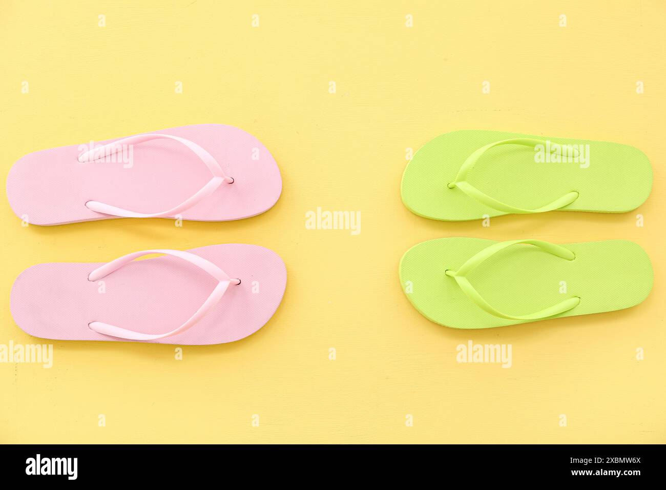 Colorful pairs of flip flops on yellow background Stock Photo - Alamy
