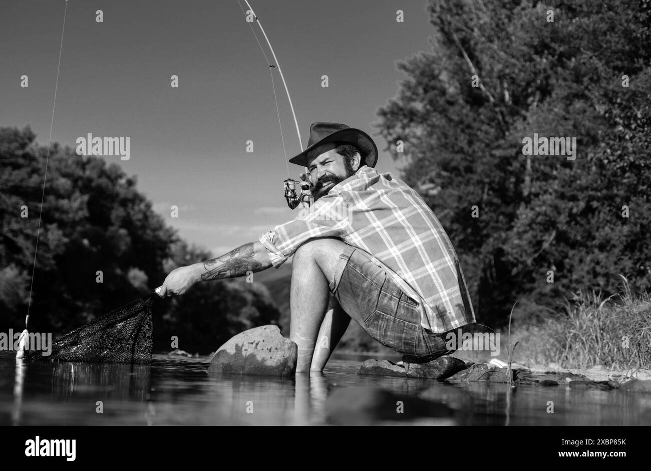 Fisherman caught fishing rod on Black and White Stock Photos & Images ...