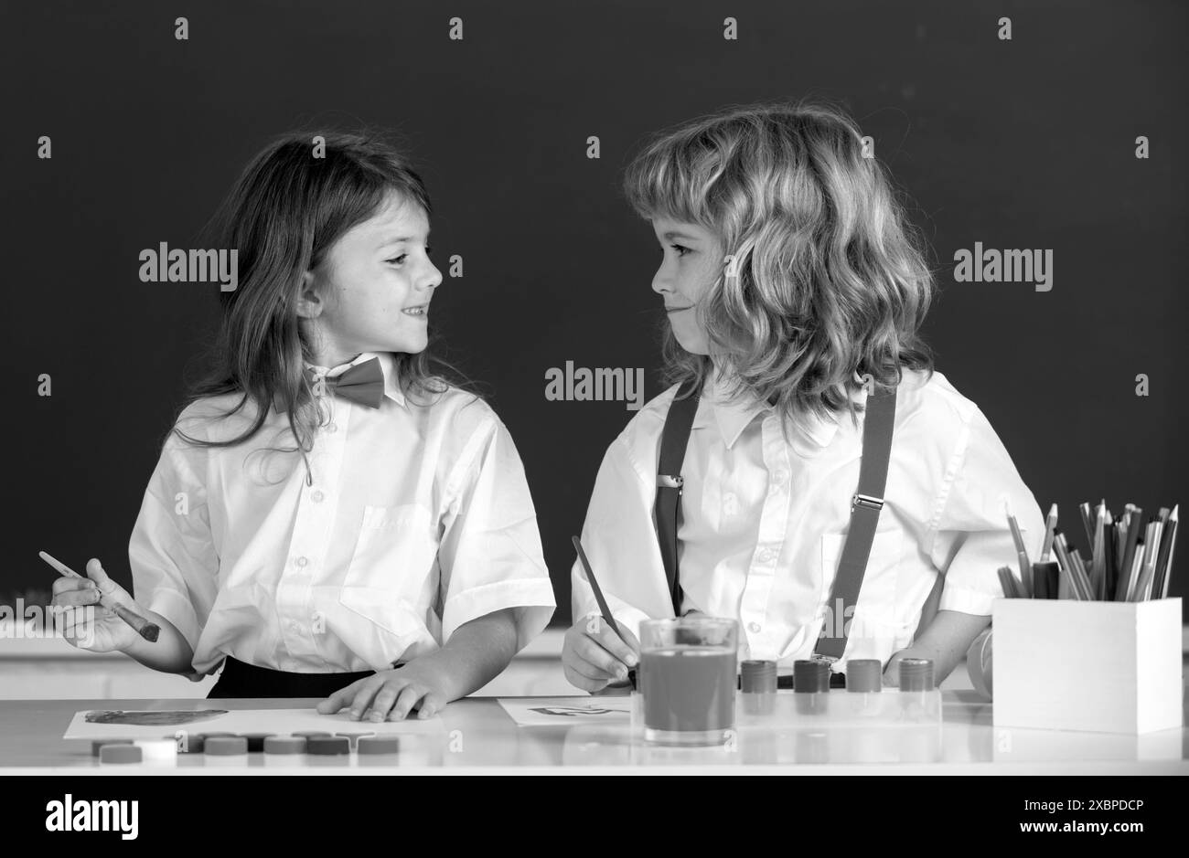 Funny pupils draws in classroom on school blackboard background. School ...