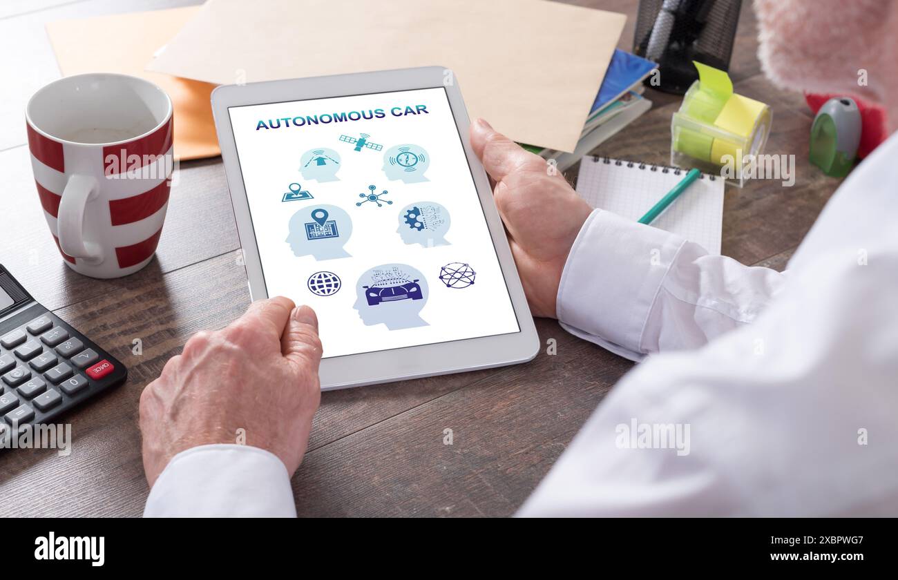 Autonomous car concept shown on a tablet held by a man Stock Photo