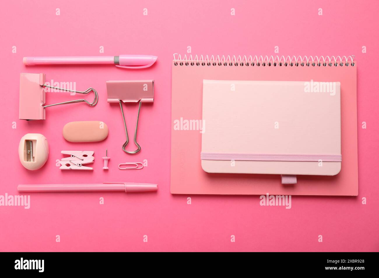 Flat lay composition with notebooks and different stationery on pink background Stock Photo