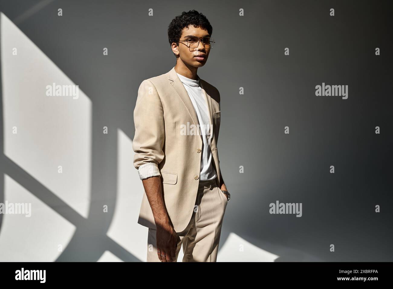 Handsome African American man in tan suit and sunglasses striking a ...
