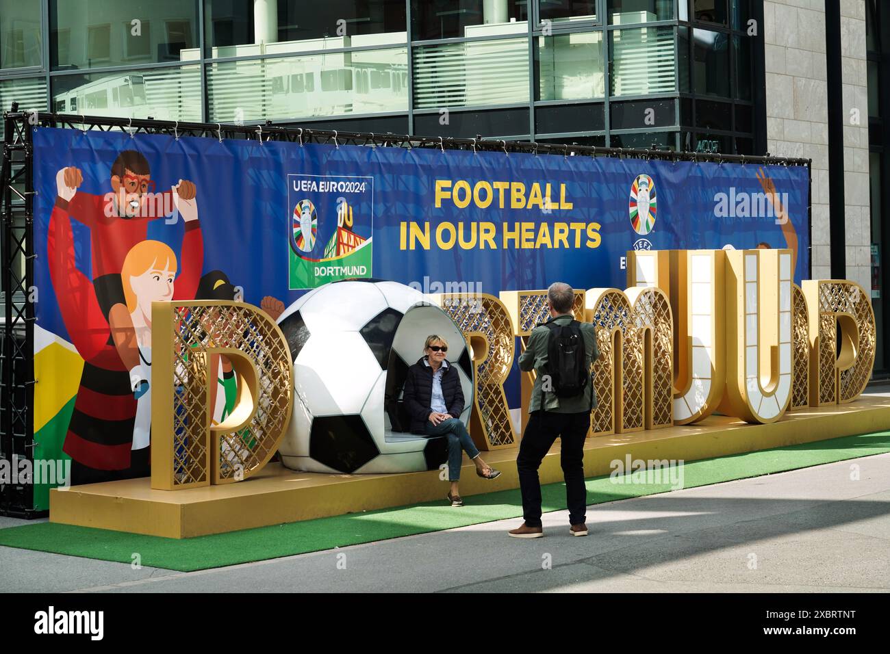 People take a picture at a large sign in Dortmund city centre welcomes visitors to the European Football Championship EURO2024, Dortmund is one of the ten host cities of the 2024 European Championship   ---   Ein großer Schriftzug in der Dortmunder City empfängt die Besucher zur Fußball-Europameisterschaft EURO2024, Dortmund ist einer der zehn Austragungsorte der Europameisterschaft 2024 Stock Photo