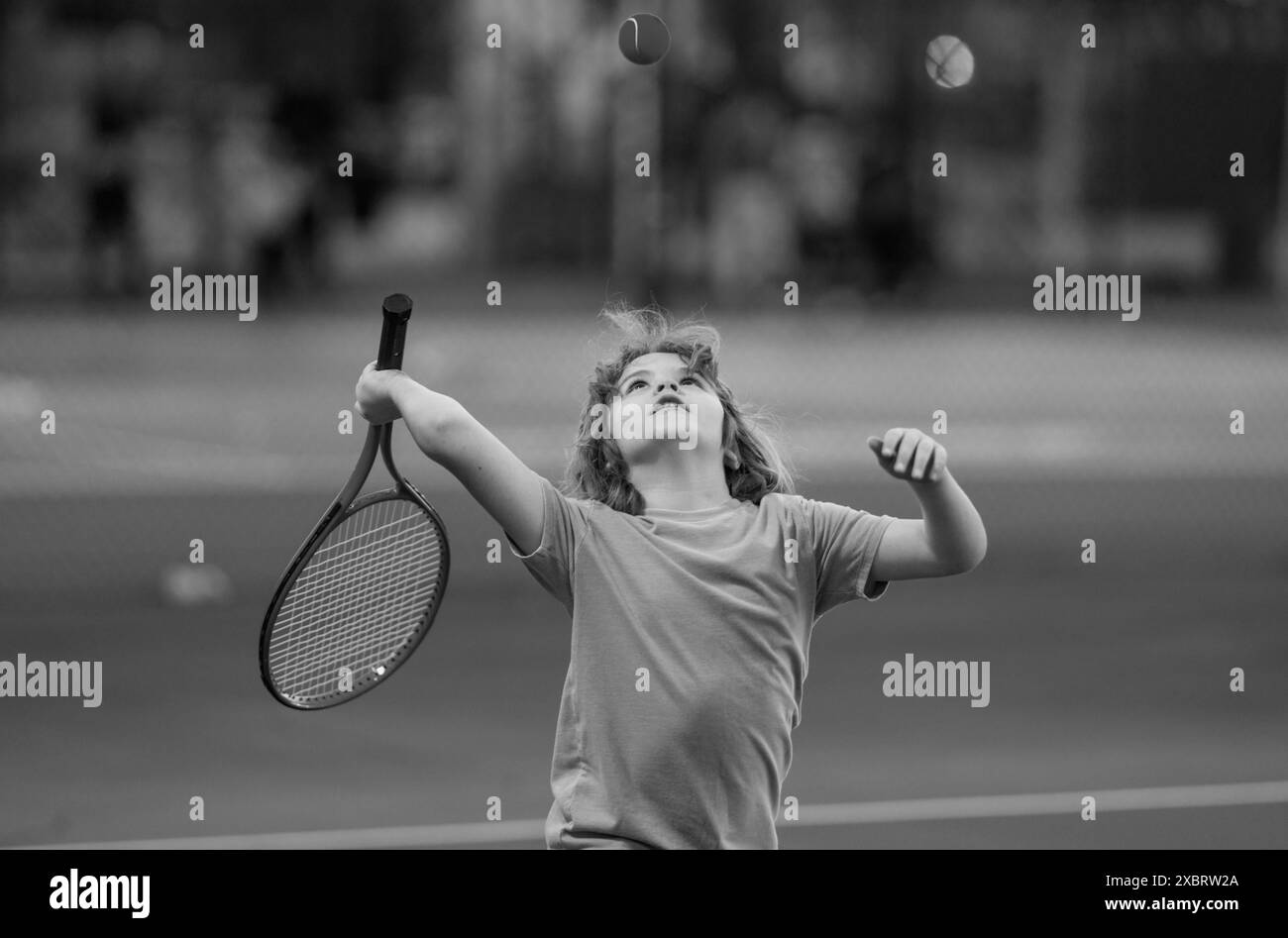 Kid playing tennis on court. Child hit tennis ball with tennis racket ...
