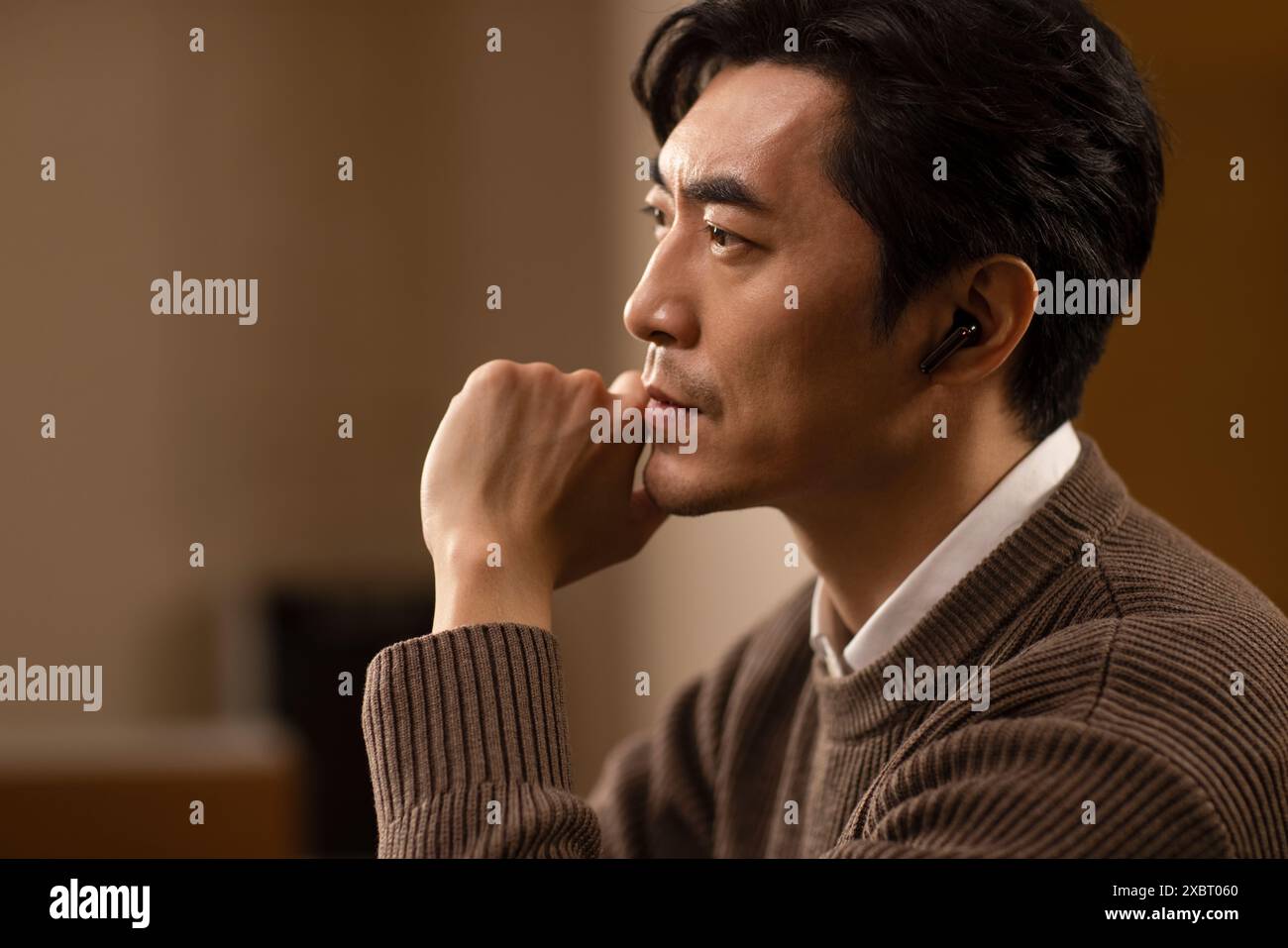 Mature Man Using Cordless Earbuds Stock Photo