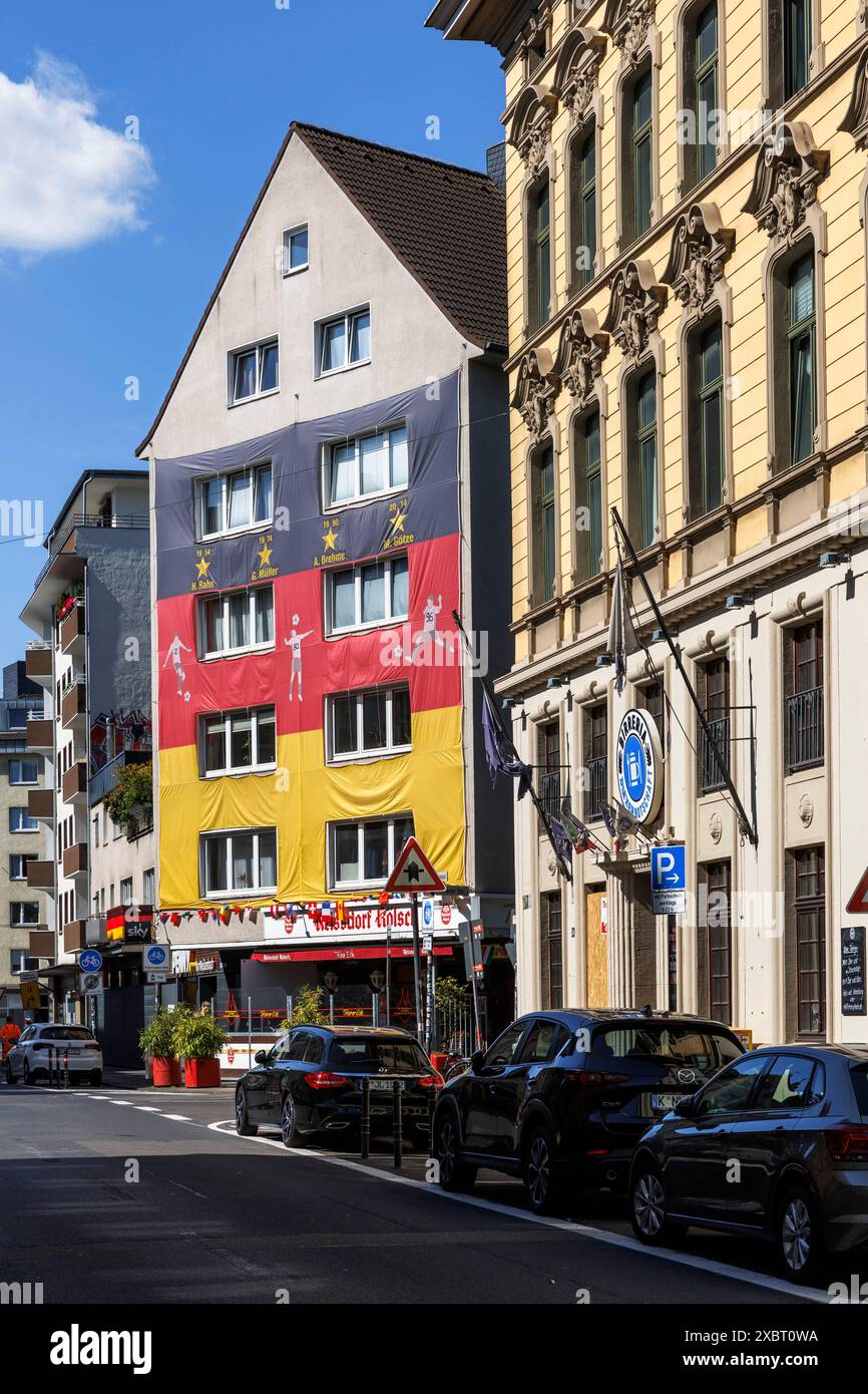 with a huge German flag covered house on the occasion of the UEFA European Football Championship 2024, Trierer street, Cologne, Germany. mit grosser D Stock Photo