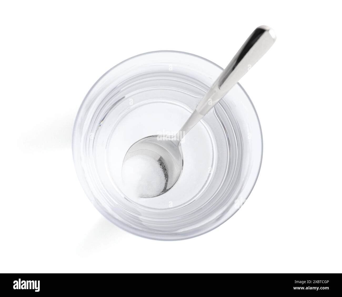 Glass of water with baking soda on white background top view stock