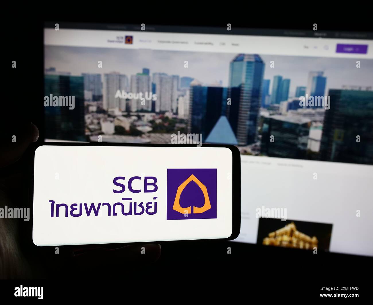 person-holding-smartphone-with-logo-of-the-siam-commercial-bank-public
