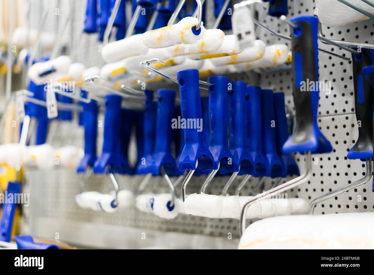 A store display of paint brushes and rollers. The display is organized ...