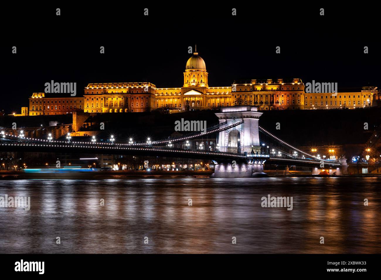 The historical Buda castle district above the Danube river illuminated ...