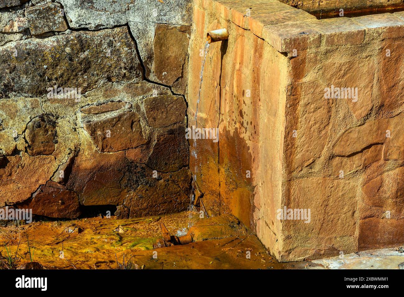 Old Water Pillar of ferruginous water (named Fuente La Teja) in the town of Fuencaliente, Ciudad Real Province, Spain Stock Photo