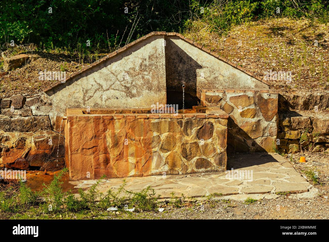 Old Water Pillar of ferruginous water (named Fuente La Teja) in the town of Fuencaliente, Ciudad Real Province, Spain Stock Photo