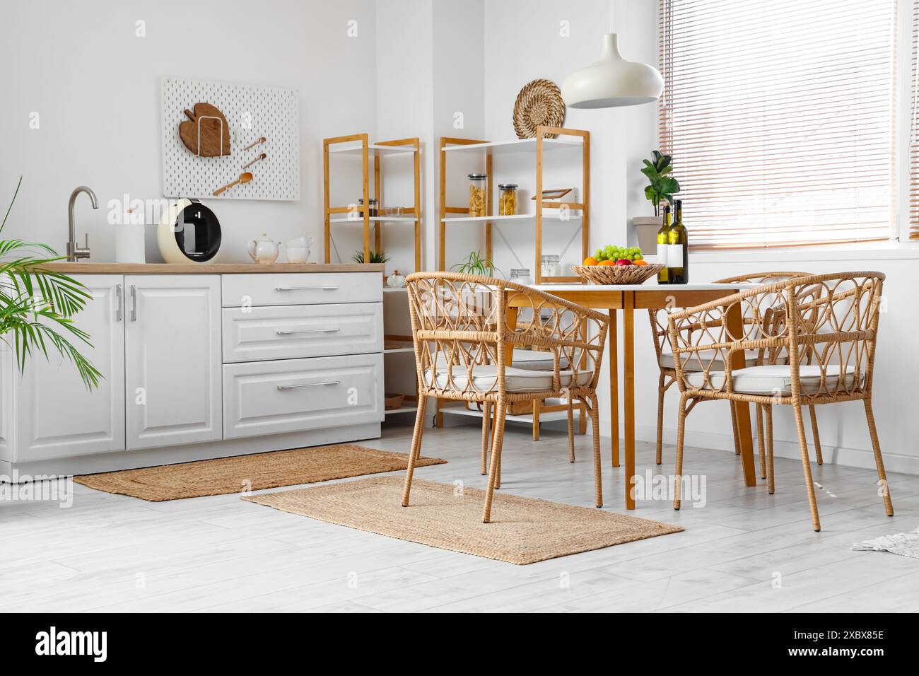 Interior of kitchen with dining table, chairs, shelving unit and lamp ...