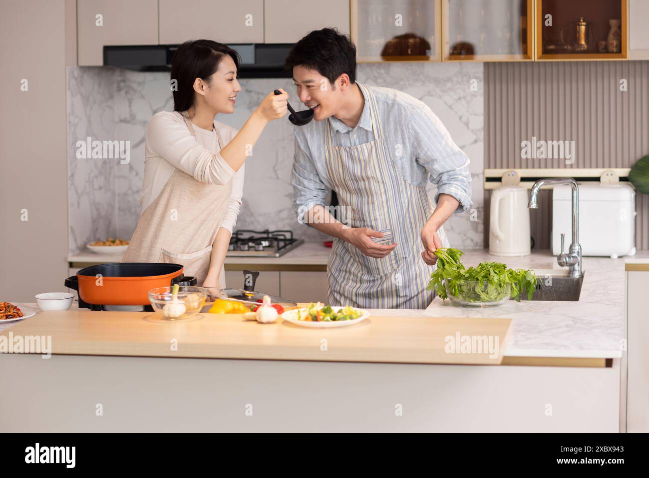 Couple Cooking In The Kitchen Stock Photo