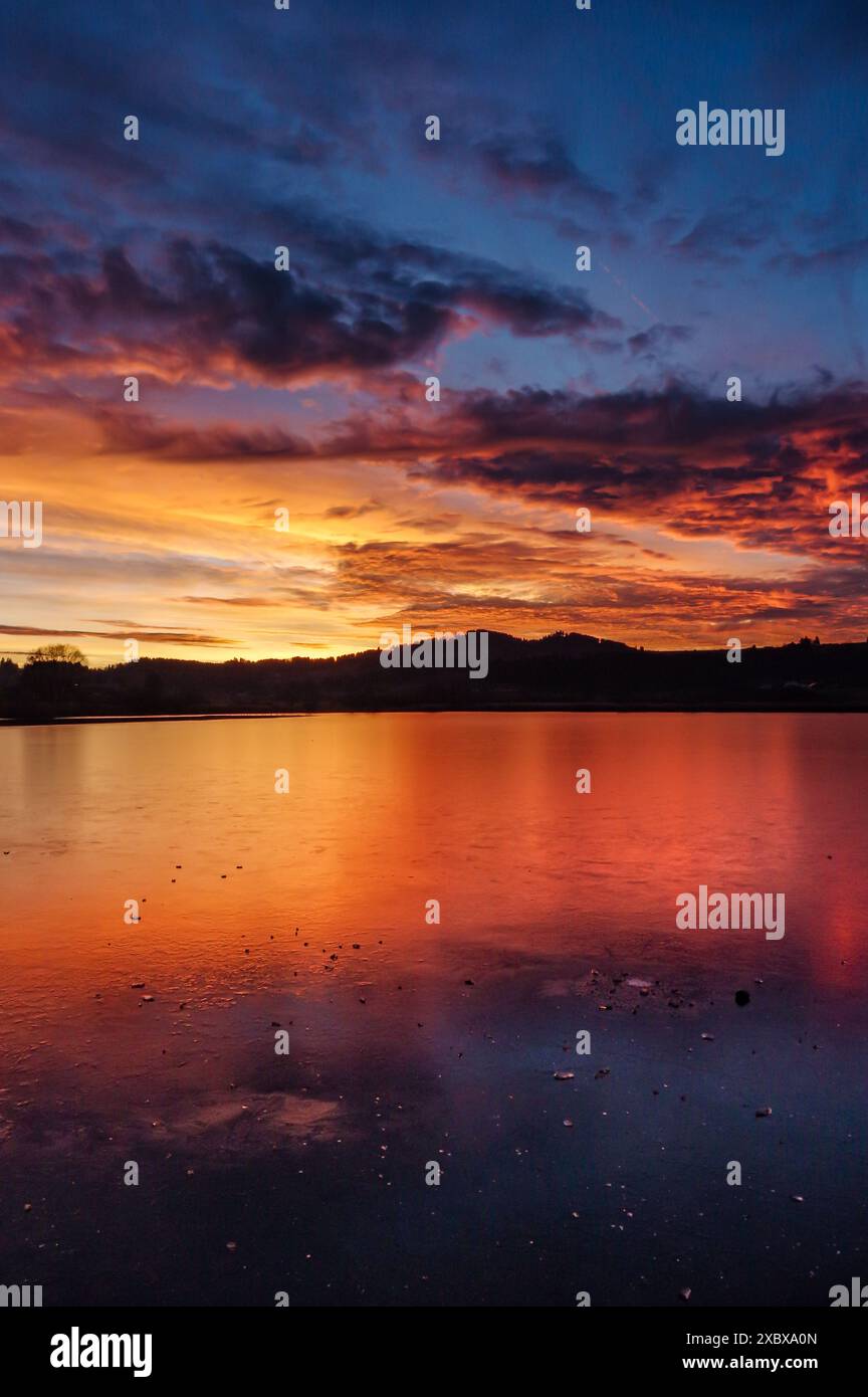 red, sun, frozen lake, sunset, amazing, reflection, sky colors, orange, blue, winter, ice, serene, peaceful, tranquil, nature, landscape, horizon Stock Photo