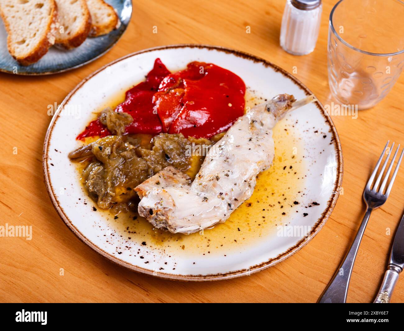 On plate is piece of dietary rabbit meat on bone with braised ...