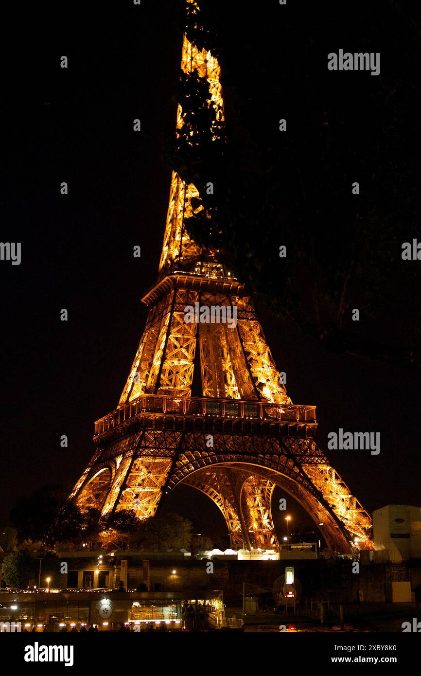 The illuminated Eiffel Tower in 2024 before the Olympic Games in the evening Stock Photo