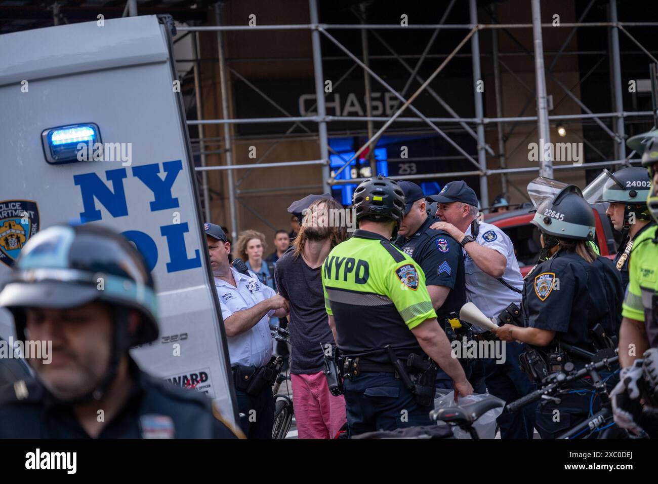 Police arrest a pro-Palestinian activist for allegedly placing a sticker on the fence that surrounds City Hall on June 13, 2024 in New York, NY. The arrest followed a rally at Citi Headquarters and march through lower Manhattan. (Photo by Matthew Rodier/Sipa USA) Credit: Sipa USA/Alamy Live News Stock Photo