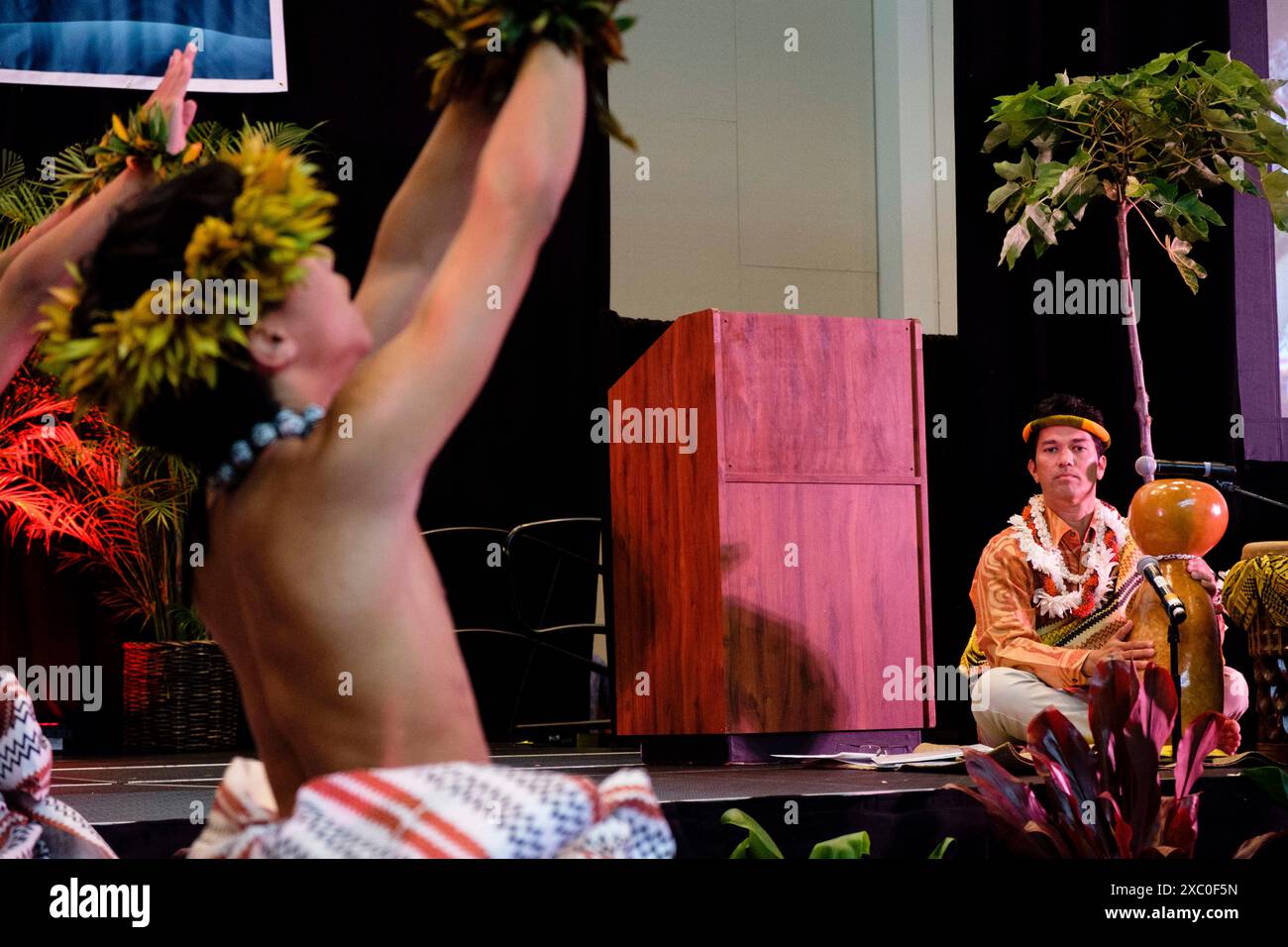 Honolulu, Hawaii, USA. 13th June, 2024. Dancers from the Kamehameha School Hawaiian Ensemble dance hula of global warming consequences ''” sea level rise, wildfire, ocean degradation ''” prior to NAINOA THOMPSON'S keynote address beseeching attendees to avail themselves of the power of Pacific nations to combat the the climate crisis. (Credit Image: © J. Matt/ZUMA Press Wire) EDITORIAL USAGE ONLY! Not for Commercial USAGE! Stock Photo