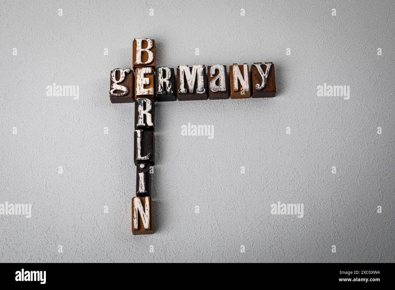 GERMANY BERLIN Alphabet blocks crossword puzzle on gray textured GERMANY BERLIN Alphabet blocks crossword puzzle on gray textured