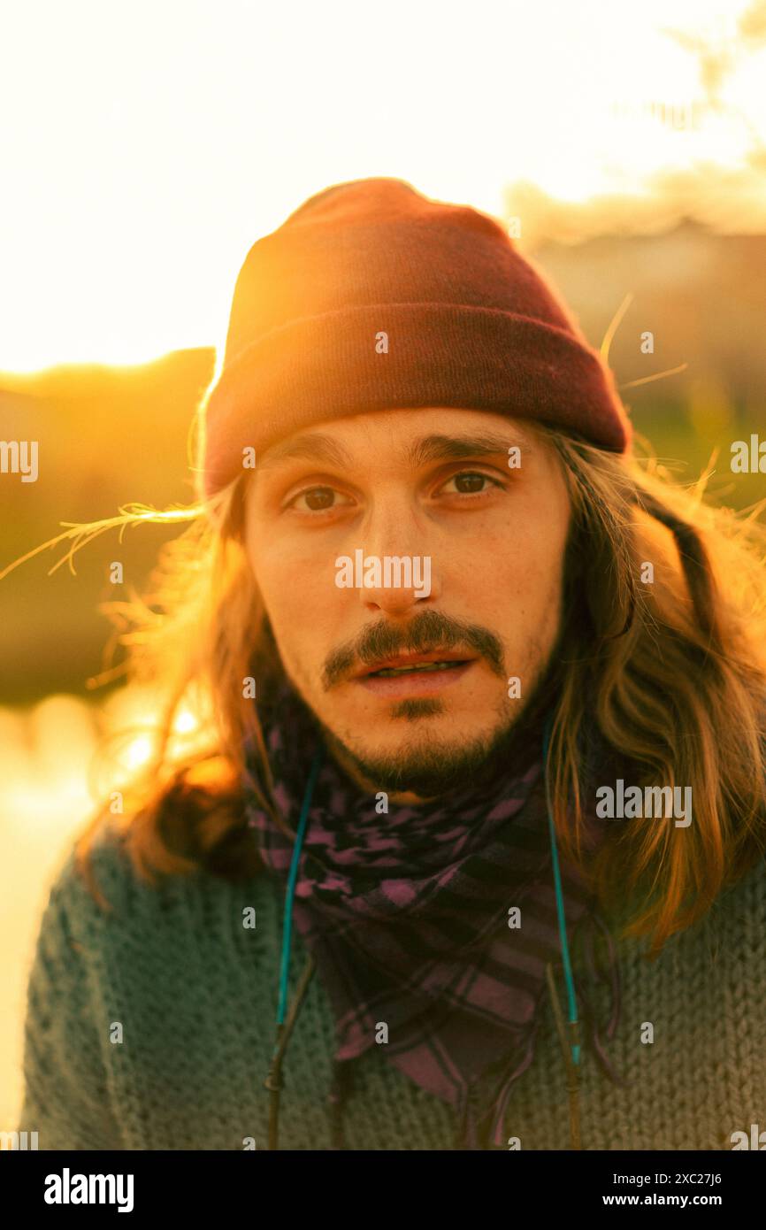 Portrait of a young long-haired man in a hat. Stock Photo