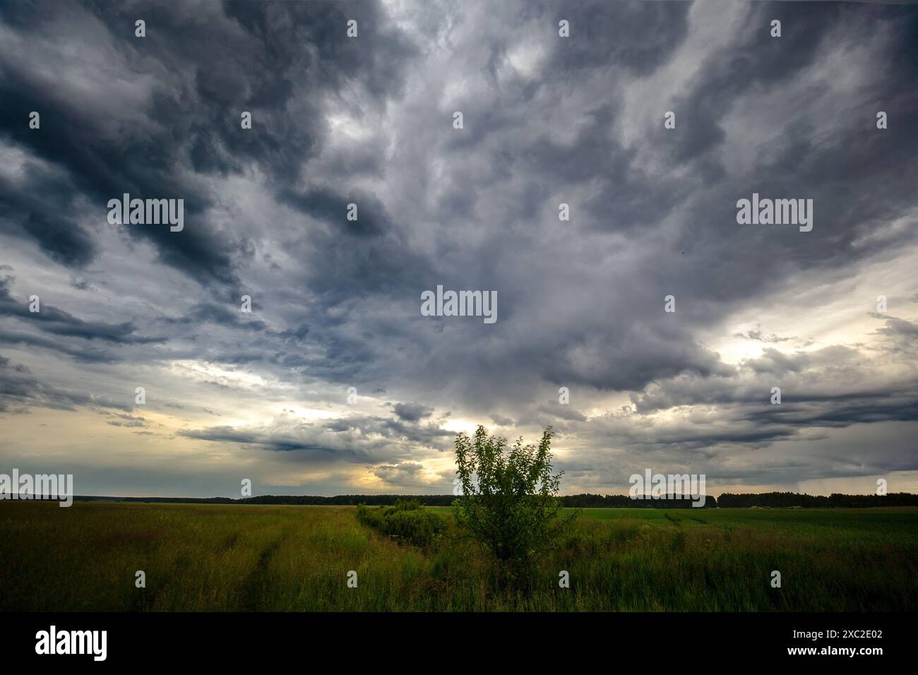 Dark stormy clouds over a country road, summer time Stock Photo - Alamy